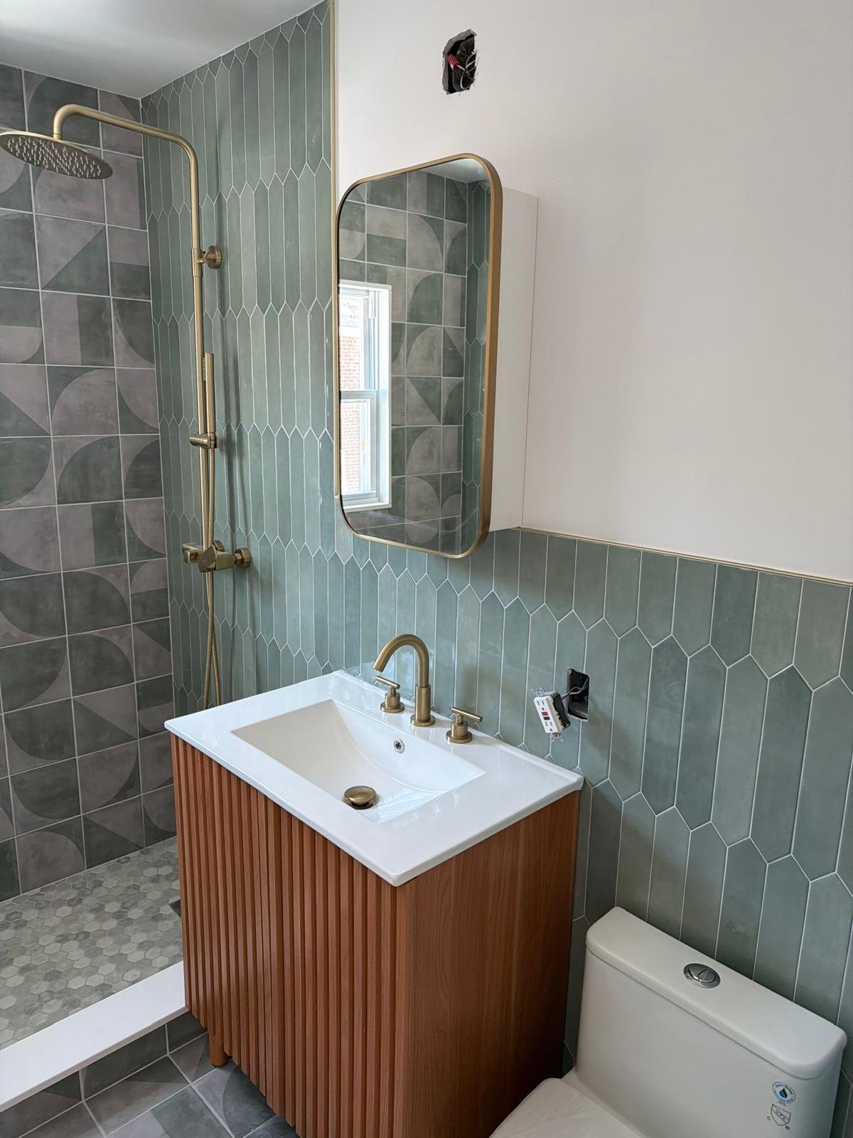 Remodeled bathroom with tile, vanity, and shower